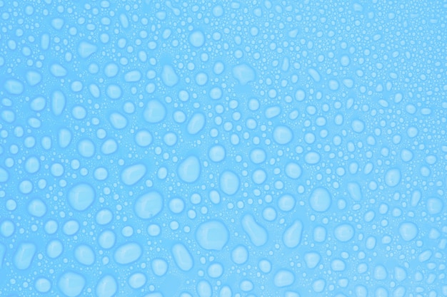 Closeup drops water on blue background