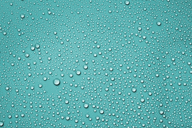 Closeup drops water on blue background