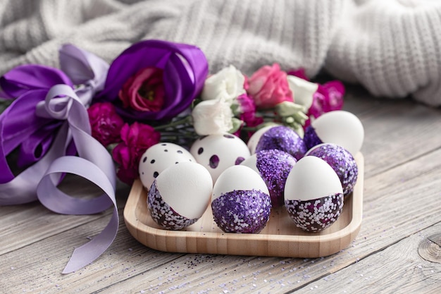 Closeup of easter eggs decorated with purple sparkles