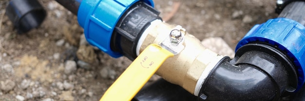 Closeup of elbow fitting pvc pipes at bend with faucet underground irrigation system plumbing