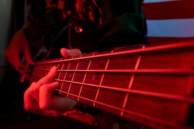Closeup of an electric bass with a red light