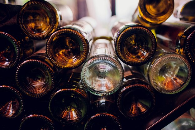 Closeup of empty bottles of wine in dark room