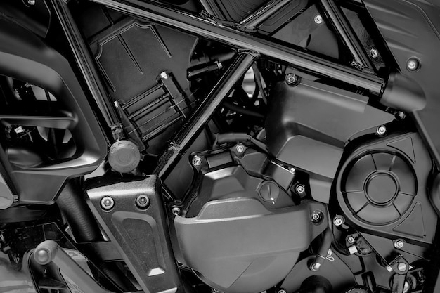 Closeup engine part of modern motorcycle on black color background