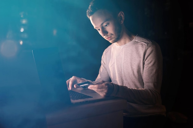 Closeup of entrepreneur using laptop and credit card for online