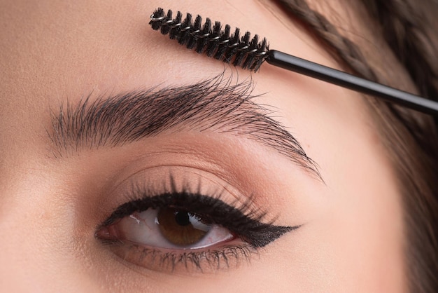 Closeup eyebrows with eyebrow brush close up brows eyebrows lamination brow procedures long eyelashe