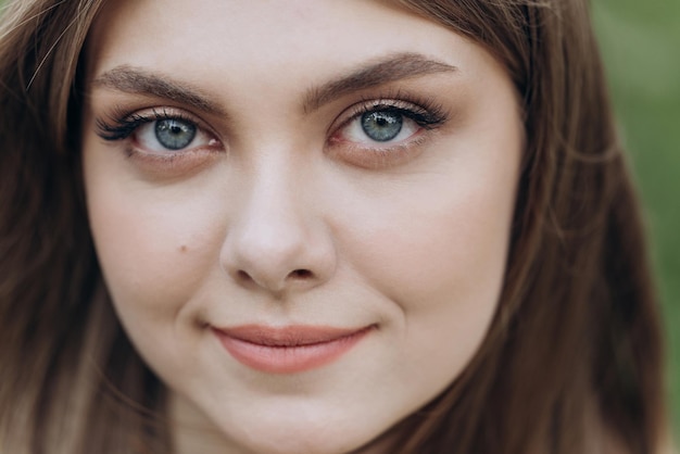 Closeup of eyes beautiful girl positive woman looking at camera girl opening her beautiful blue eyes