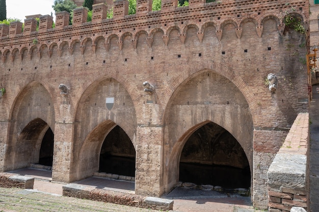 Closeup facade of Fontebranda is one of the medieval fountains of Siena, located in Terzo di Camollia