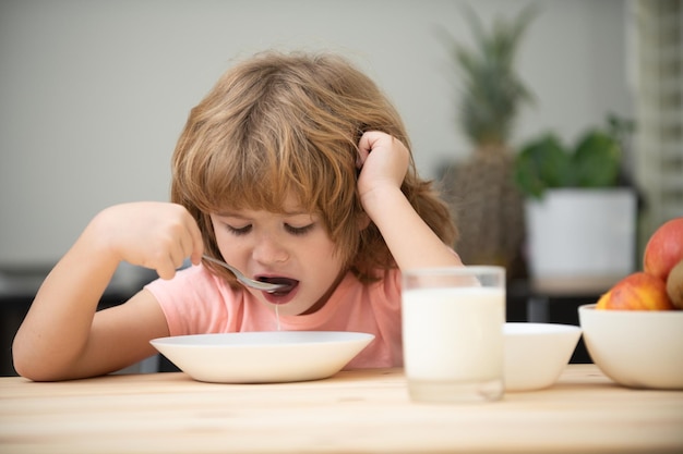 Closeup face of kid eating organic food yogurt milk Child healthy eat