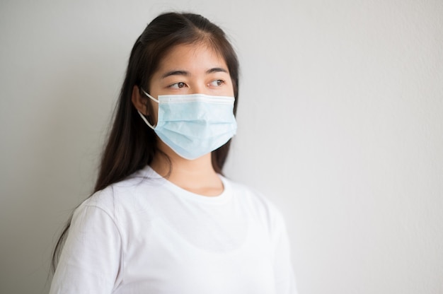 Closeup face portrait Female university Asian students wear a mask and keep social distances during school hours.