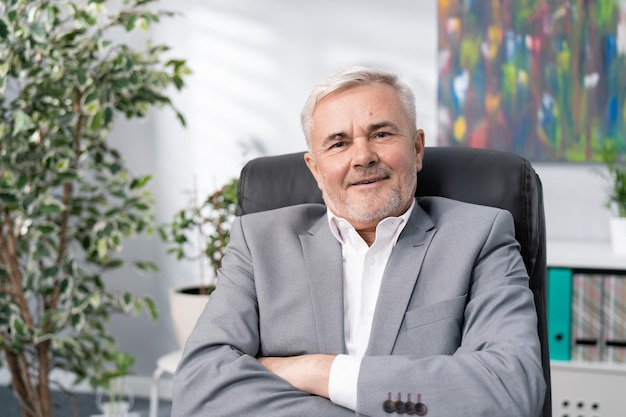 Closeup of face of smiling man in white shirt jacket