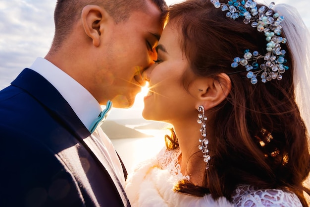 Closeup faces of the newlyweds with closed their eyes