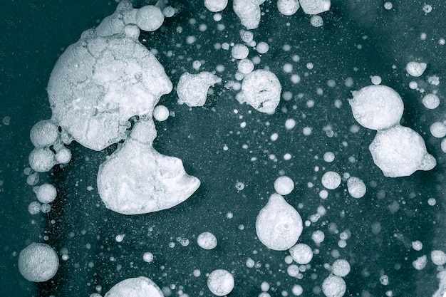 Closeup of fat and oil spots on water surface dirty pan with food leftover as background or texture