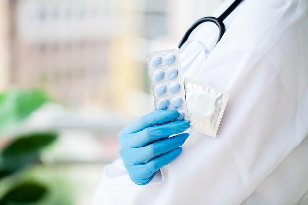 Closeup of female doctor holding pill for men health