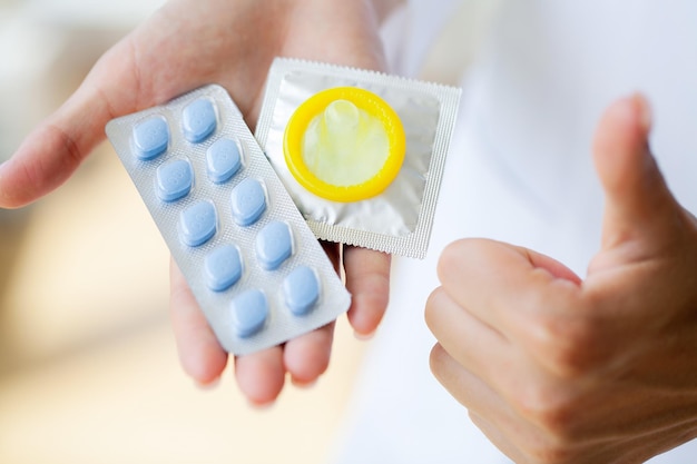 男性の健康のための錠剤を保持している女性医師のクローズアップ