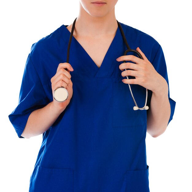 Closeup of female doctor's hand holding stethoscope over white background