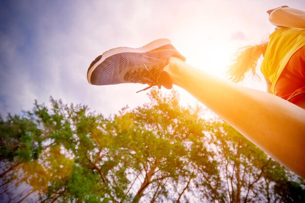 Closeup of female feet running at the park