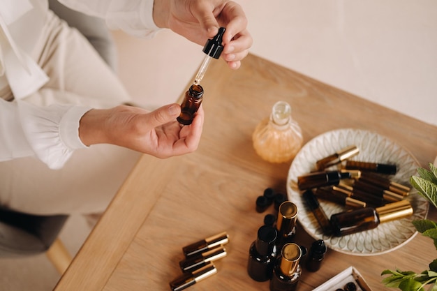 Closeup of female hands holding a bottle of essential oil Aromatherapy