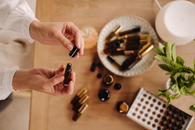 Closeup of female hands holding a bottle of essential oil Aromatherapy