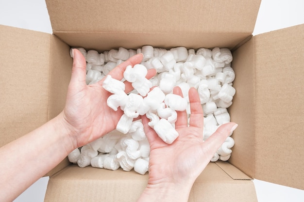 cardboard box with packing foam pellets top view, isolated on