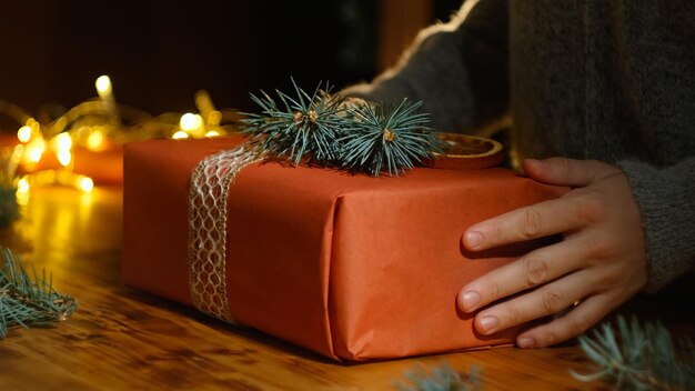 Closeup of female hands with Christmas present