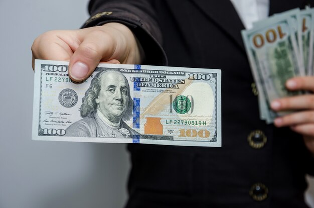 closeup female hands with dollars