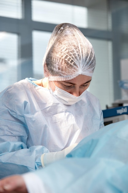 Closeup of a female surgeon in an operating room a doctor with a tense expression on his face in an operating room