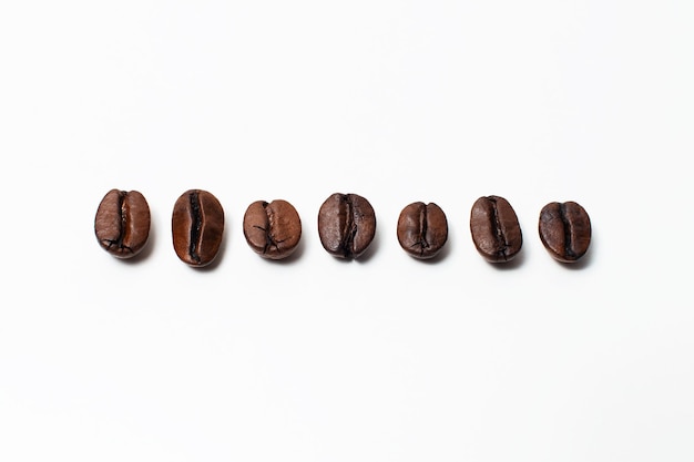 Closeup of few coffee beans isolated on white background