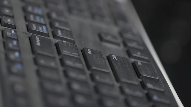 Closeup of finger over black laptop keys pressing enter button computers and technologies concept