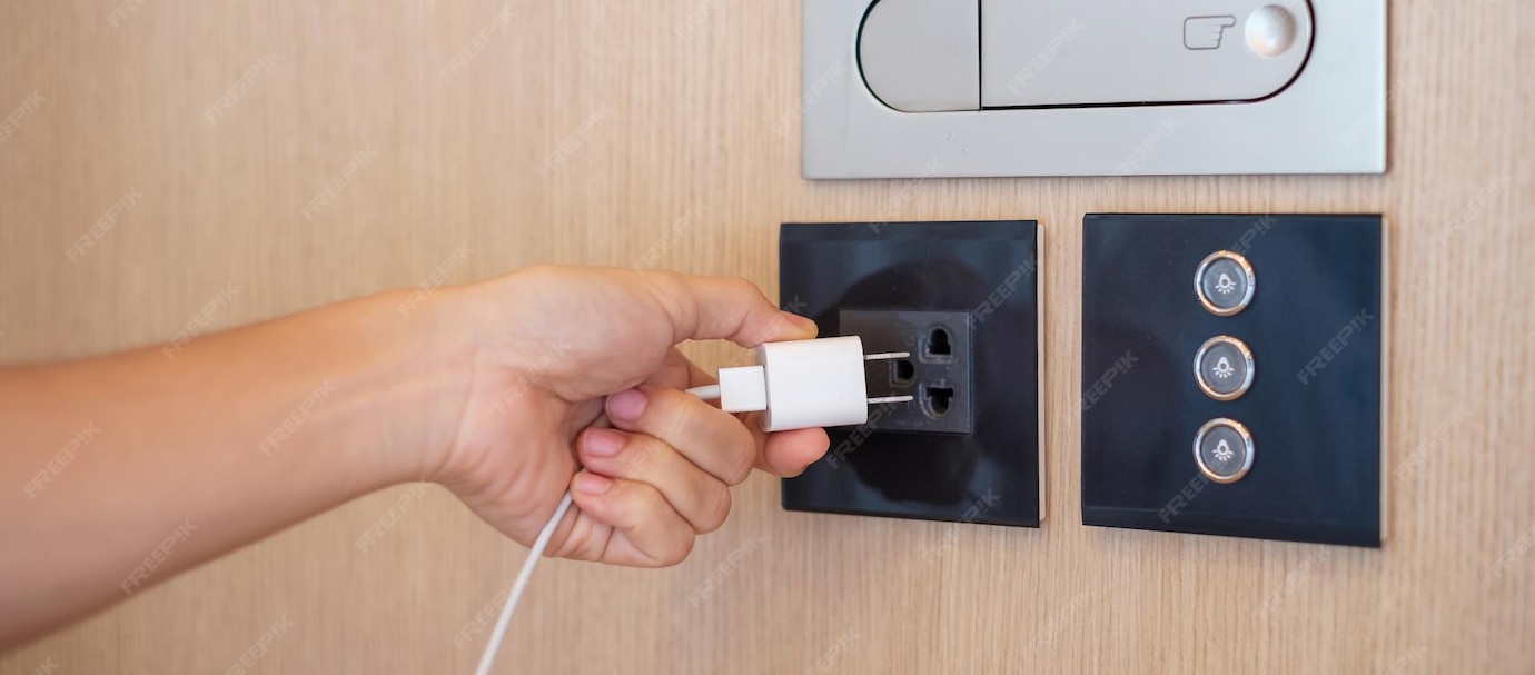 Premium Photo Closeup finger unplugging or plugging of electricity