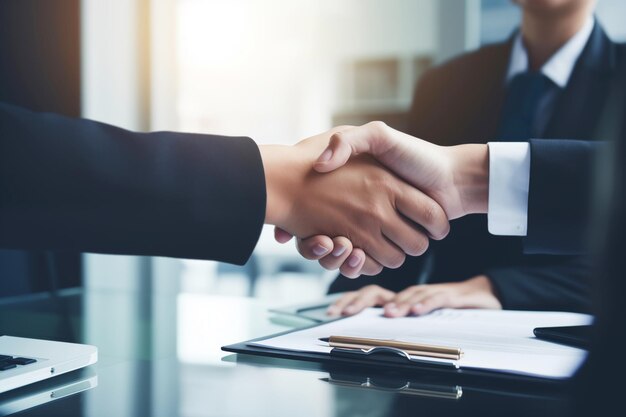 Closeup of firm handshake between business professionals in modern office