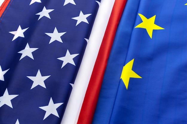 Closeup of Flags of USA and European Union lying together on table