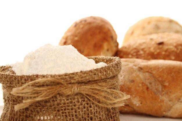 Closeup of flour in a bag and different types of bread Isolate