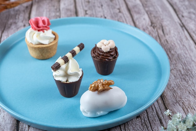 Closeup of four small fancy candies filled with chocolate ganache and whipped cream and fondant