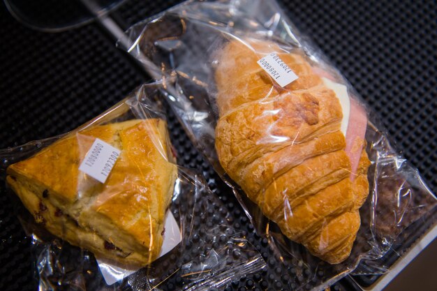 Closeup of fresh pastry in plastic bags on a table