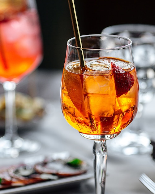 Closeup on fresh sweet aperol spritz cocktail in a wine glass