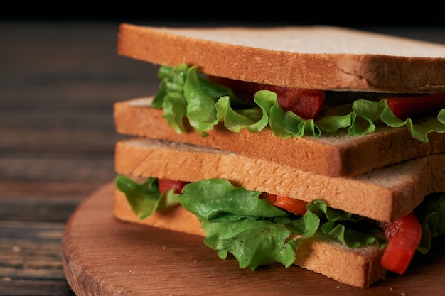 Closeup fresh tomato sandwich on wooden table