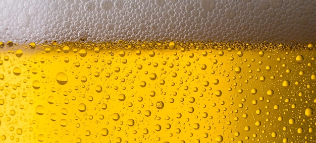 A closeup from a beer glass with dew drops and froth. ideal for websites and magazines layouts