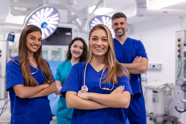 Closeup front view of group of mixed age doctors and nurses standing side by side and looking at the camera Young female doctor is in the front