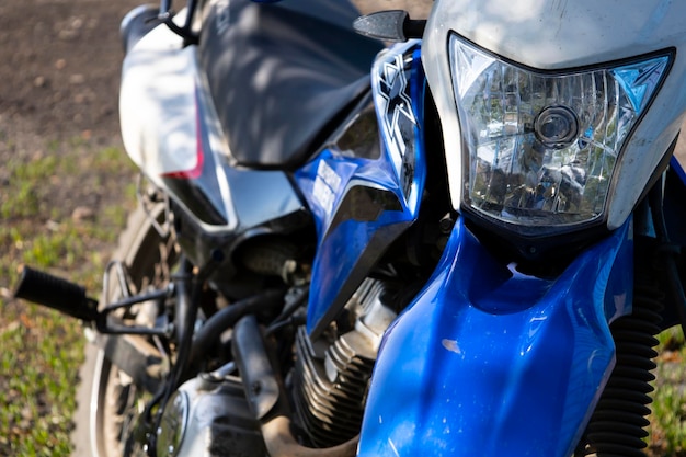 Closeup of the front wheel of the motorcycle parked on the grass