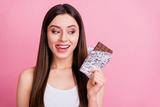 closeup of funny lady hold big chocolate bar licking lips