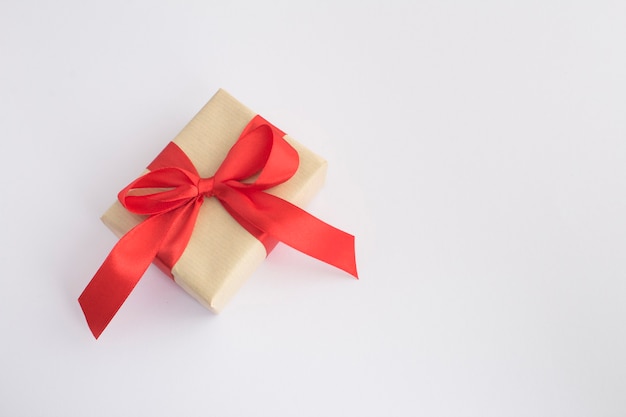 Closeup on gift  with red ribbon on the white background