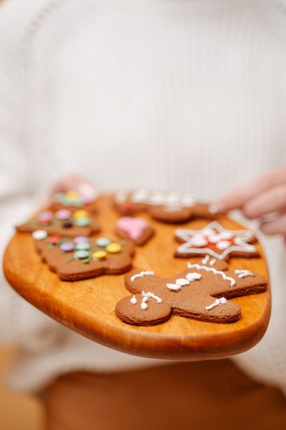 Closeup of ginger traditional cookies for christmas in different shapes on a wooden board