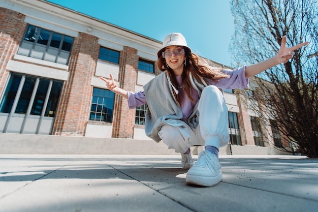 Closeup girl staring at camera portrait of charming female person dancing on the street high quality