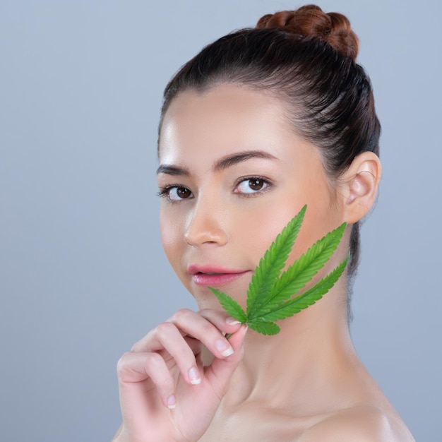 Closeup glamorous woman hold green leaf as cannabis beauty concept