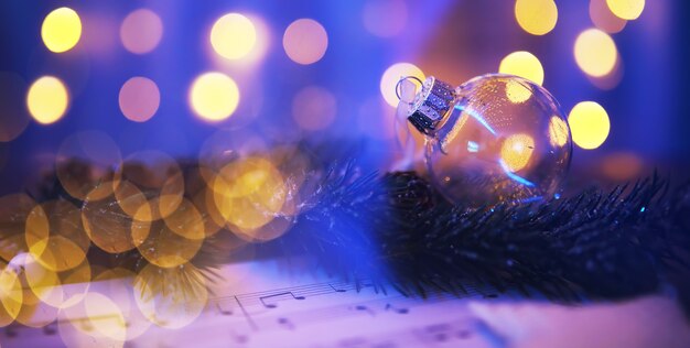 Closeup of glass Christmas ball on abstract light background.