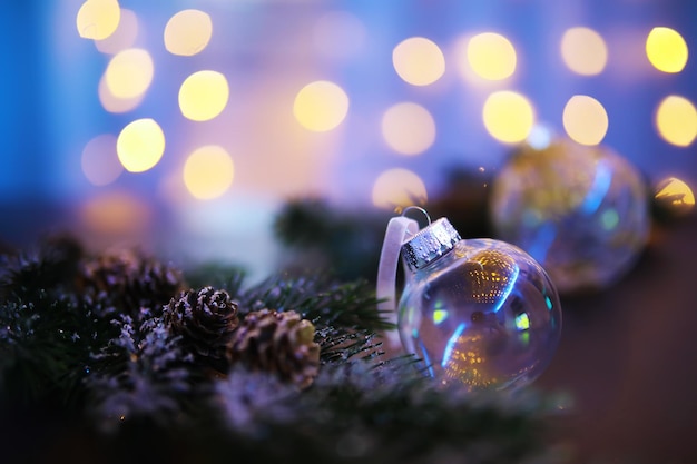 Closeup of glass Christmas ball on abstract light background.