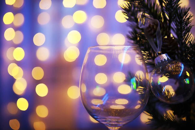 Closeup of glass Christmas ball on abstract light background.