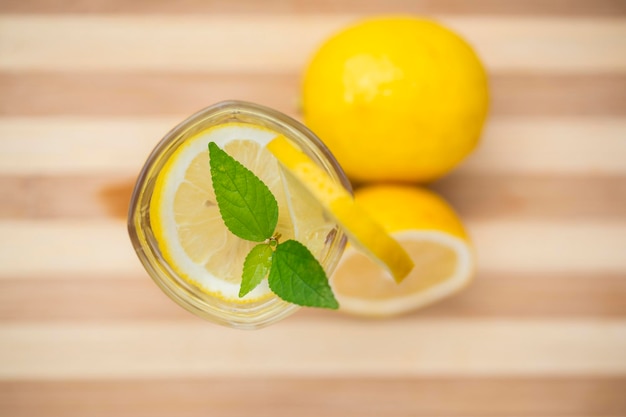 Closeup glass of lemonade on red tabletop