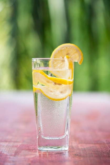 Closeup glass of lemonade on red tabletop