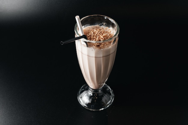 Closeup glass of milk shake isolated on black surface